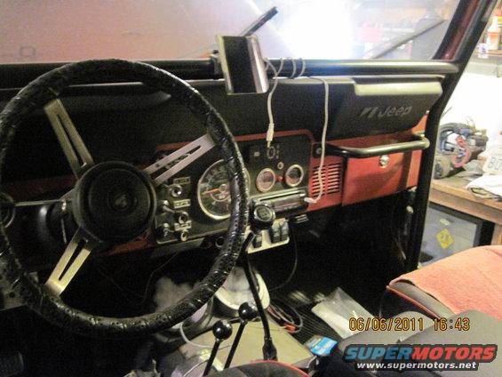 Jeep CJ interior with aftermarket radio and roll bar