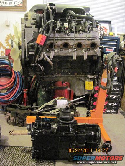 Engine and transmission assembly on an orange engine stand