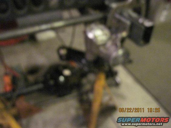 close-up of vehicle drivetrain parts, possibly a differential and suspension components