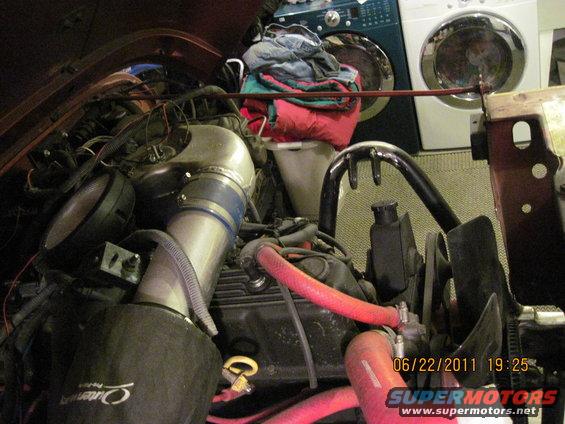 Engine bay with custom intake and red hoses. Date stamp 06/22/2011
