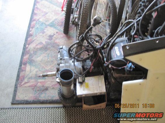 Transmission and engine parts with visible wiring and a date stamp
