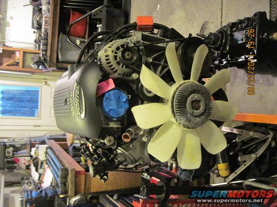 Vortec engine assembly with fan and alternator visible. Date stamp reads 06/22/2011