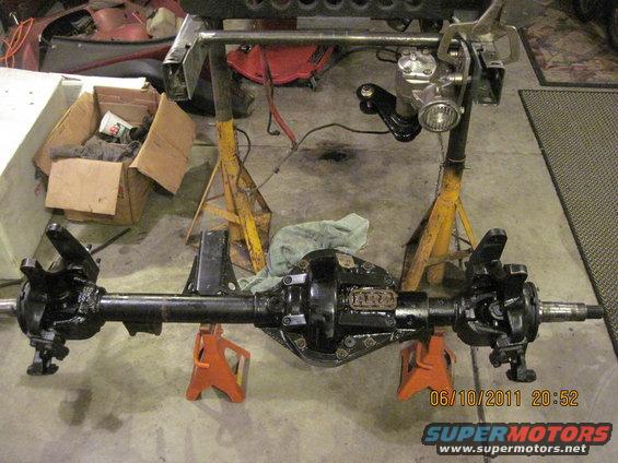 Jeep Dana 44 front axle assembly on jack stands, with steering components attached