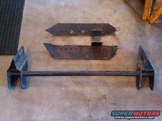 Custom suspension parts laid out on concrete floor