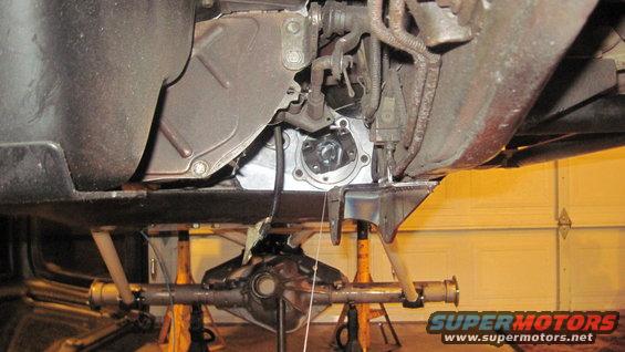 Underside view of vehicle drivetrain and rear axle on jack stands
