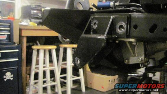 Black Jeep frame section with suspension parts, viewed from below and front