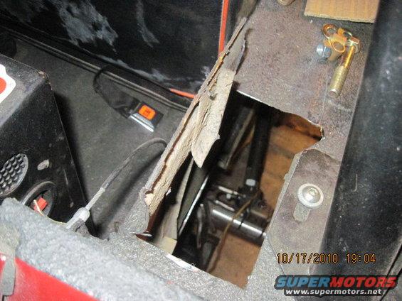 Interior floor damage reveals mechanical parts and a date stamp