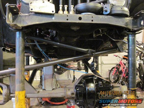 Jeep chassis on jack stands, showing suspension and differential work. Date stamp reads 04/18/2011