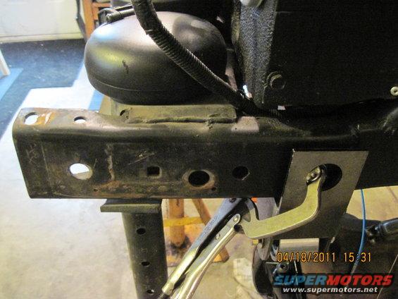 Close-up of vehicle frame with a clamp attached to a bracket