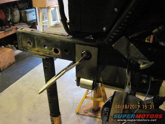 Jeep CJ frame section with a jack and metal bracket attached