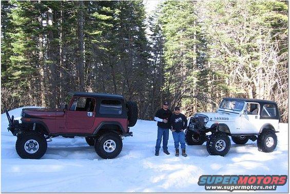 Red Jeep CJ-series with black top and spare tire on rear, next to white Jeep CJ-series with black top, two men stand between them in snow