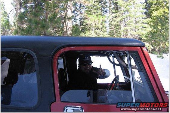 Red Jeep CJ-series interior with man giving shaka sign