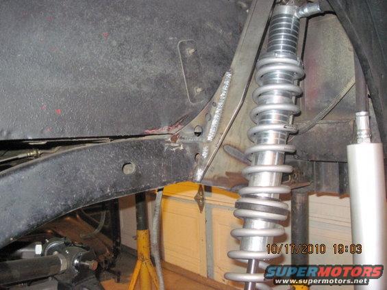 Close-up of a modified suspension system with a coilover shock absorber mounted to the frame