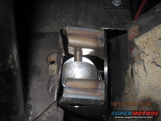 Close-up of a custom suspension component with a threaded bolt and metal brackets, date stamp 10/17/2010