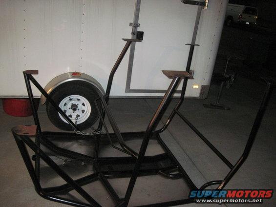 Black metal frame with a trailer wheel and fender