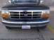 1994 Ford Bronco - Front view of a black Ford truck, a prominent chrome grille and a Washington state license plate.