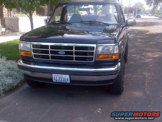 Front view of a black 1994 Ford Bronco with a chrome grille and license plate ATJ3304