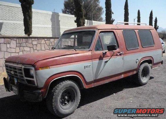 Ford Bronco with two-tone red and gray paint, roof rack, and aftermarket wheels