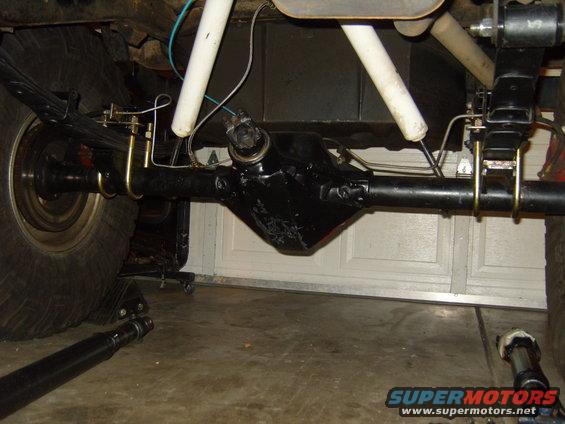 Rear axle assembly with U-bolts and shock absorber