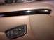 1994 Ford Bronco - Close-up of a vehicle's interior door panel, showing power window controls and a decorative trim piece.