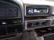 1994 Ford Bronco - The dashboard of a 1994 Ford Bronco features an aftermarket stereo and climate controls.