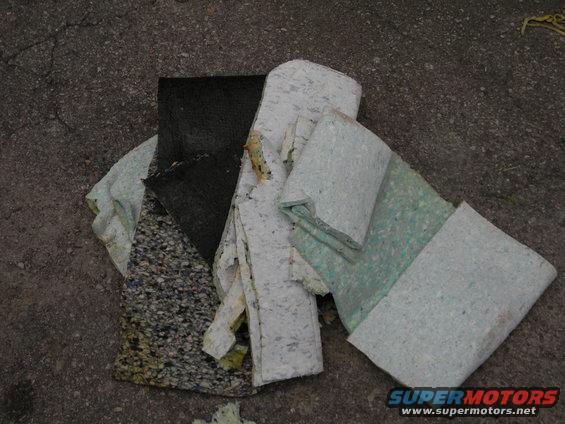 Car seat foam and padding pieces on asphalt