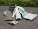 1994 Ford Crown Victoria - Scrap foam and carpet pieces are piled on the ground next to a screwdriver.
