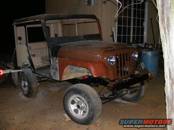 Jeep CJ-5 body, brown and tan, missing doors and roof, on trailer