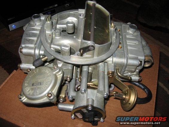 Close-up of a Holley carburetor with "PERFORMANCE CARBURETOR" visible on a cap