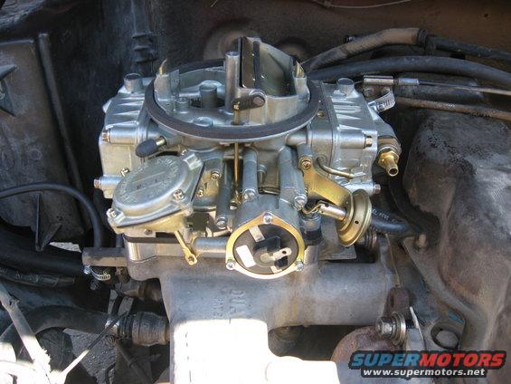 Close-up of a Holley carburetor with visible linkages and vacuum lines