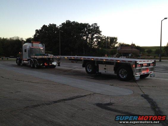 2003 Peterbilt 379 semi-truck with a flatbed trailer parked on pavement