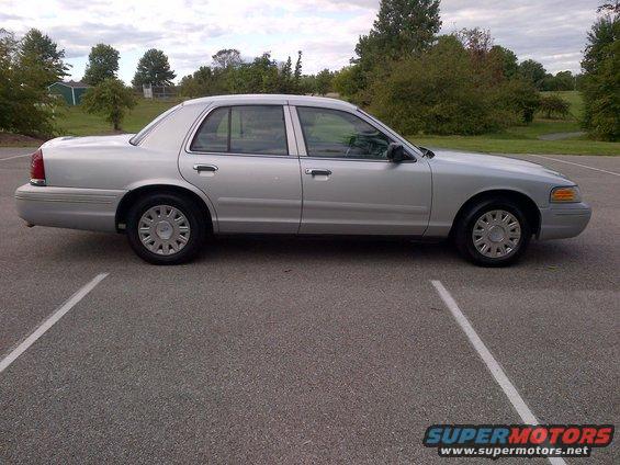 Silver sedan parked in a lot. It's a 2001 Ford Crown Victoria