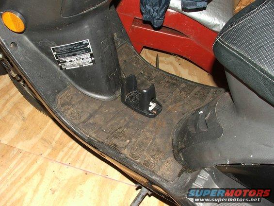 Black scooter floorboard with rubber matting and a black plastic holder