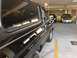 1978 Ford Bronco - Side view of a black 1978 Ford Bronco in a parking garage with other vehicles.