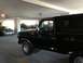 1978 Ford Bronco - A black 1978 Ford Bronco is parked in a dimly lit parking garage, with other vehicles in the background.