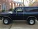 1978 Ford Bronco - A black 1978 Ford Bronco is parked in front of a brick house.