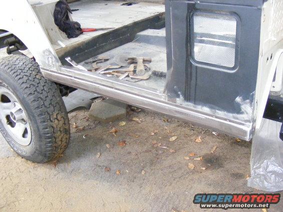 Side panel and tire of a Jeep CJ-7 undergoing repair