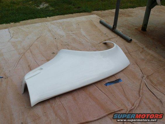 White car fender part laid out on a drop cloth