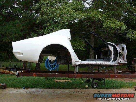 car body on trailer, missing doors and front clip