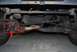 1996 Ford F-150 - A close-up view of a vehicle's undercarriage, highlighting suspension and steering mechanisms.