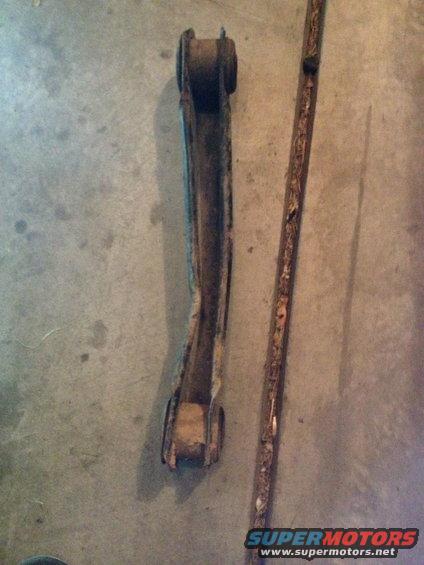 Control arm and rusty metal strip on concrete floor