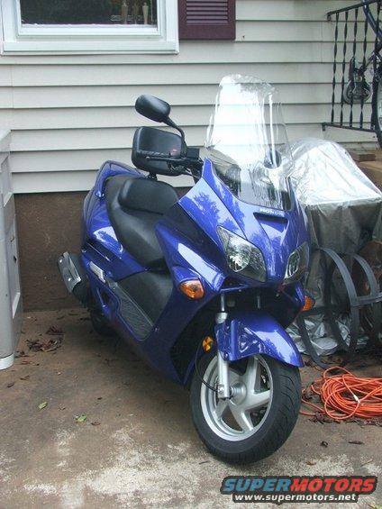 2006 Honda Reflex scooter, blue, parked on concrete driveway