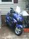 2006 Honda Reflex - Front view of a blue 2006 Honda Reflex scooter parked outdoors.