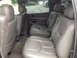 2005 Chevrolet Suburban - Interior view of a 2005 Chevrolet Suburban, highlighting the spacious seating arrangement and gray leather upholstery.