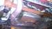 2005 Chevrolet Suburban - Underside view shows exhaust pipes and transmission pan, with some rust visible on components.
