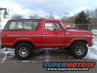 Red 1978 Ford Bronco, side view, black hardtop, chrome trim, aftermarket wheels