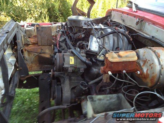 engine bay with some rust, looks like a Ford truck or Bronco