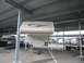 2008 Ford F-450 - A truck camper is parked under a covered lot alongside other vehicles and a boat.