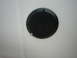 2008 Ford F-450 - A round black speaker is installed in a white ceiling or wall surface.