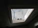 2008 Ford F-450 - Interior view of an RV skylight with its shade partially down and a manual latch.